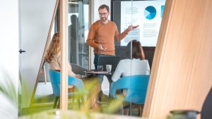 A person standing in front of a screen networking for Growth in the Accounting Industry