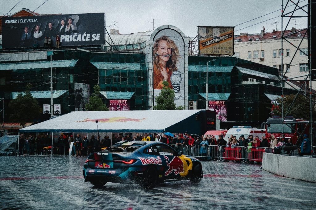 A race car driving through a city