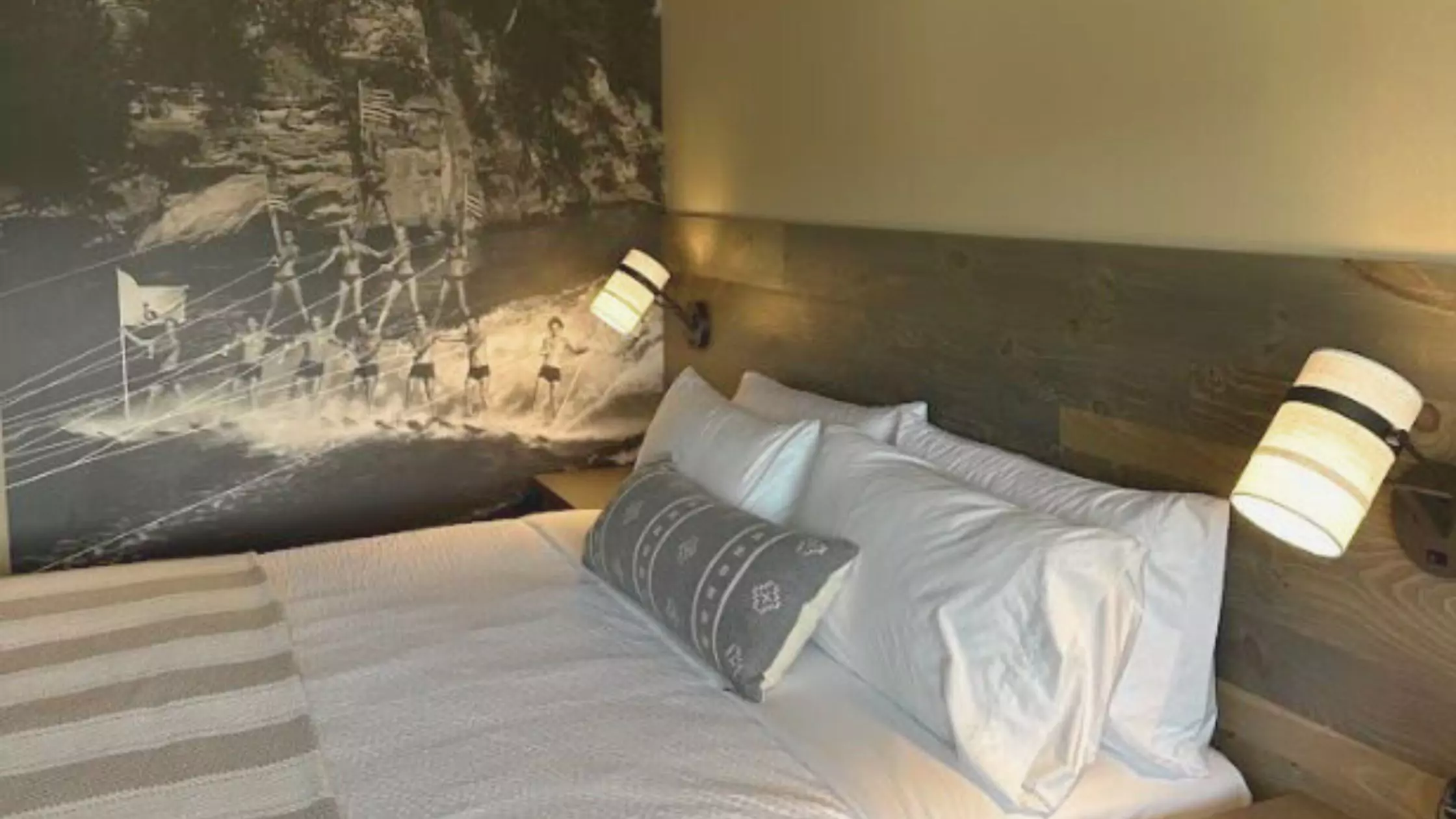 A bed with white sheets and pillows - The Wisconsin Hotel